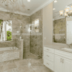 Luxurious bathroom with tile, tub, and glass shower.