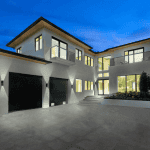 Modern house with large windows at twilight.